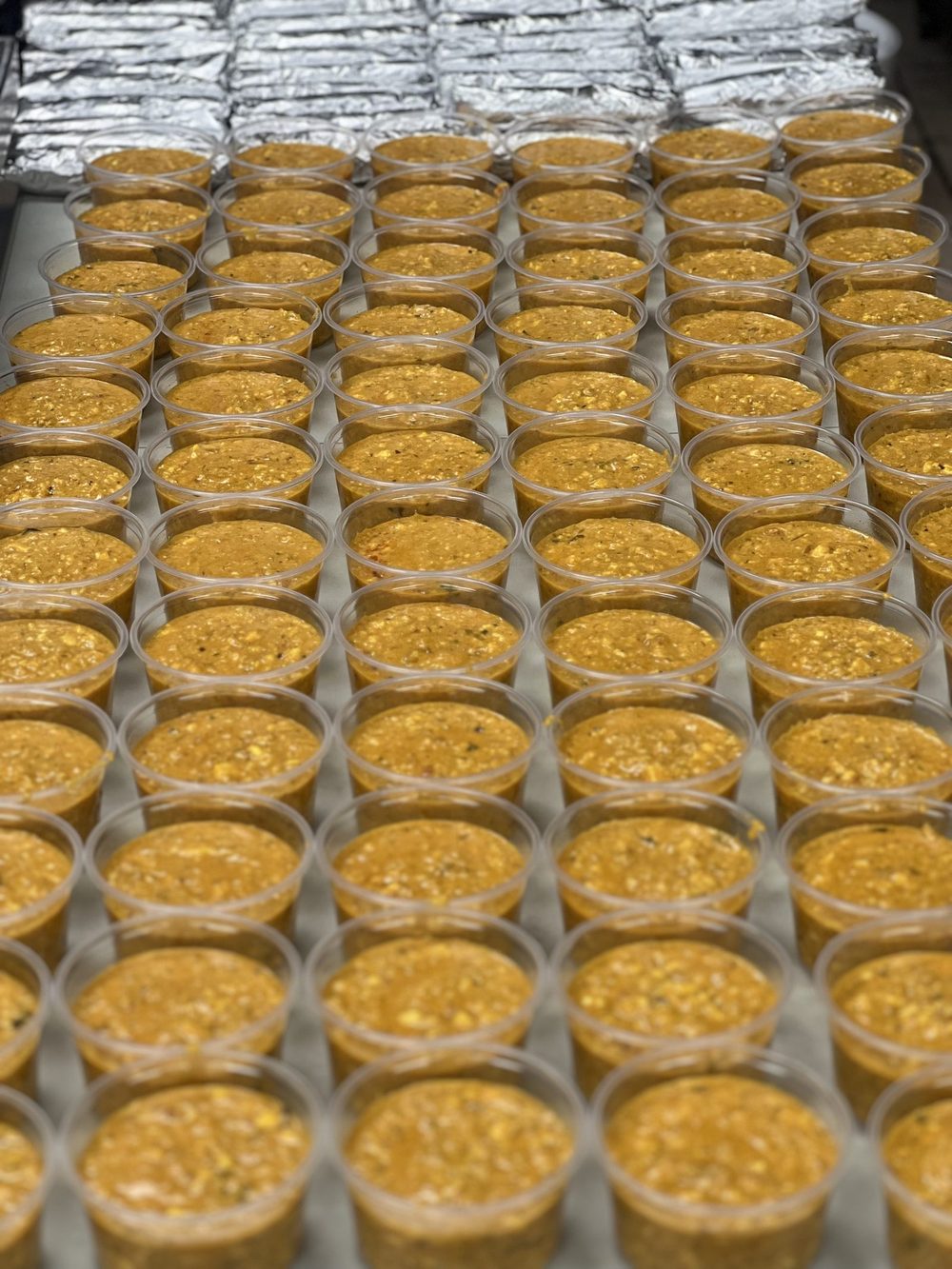 Rows of dessert cups prepared for an event