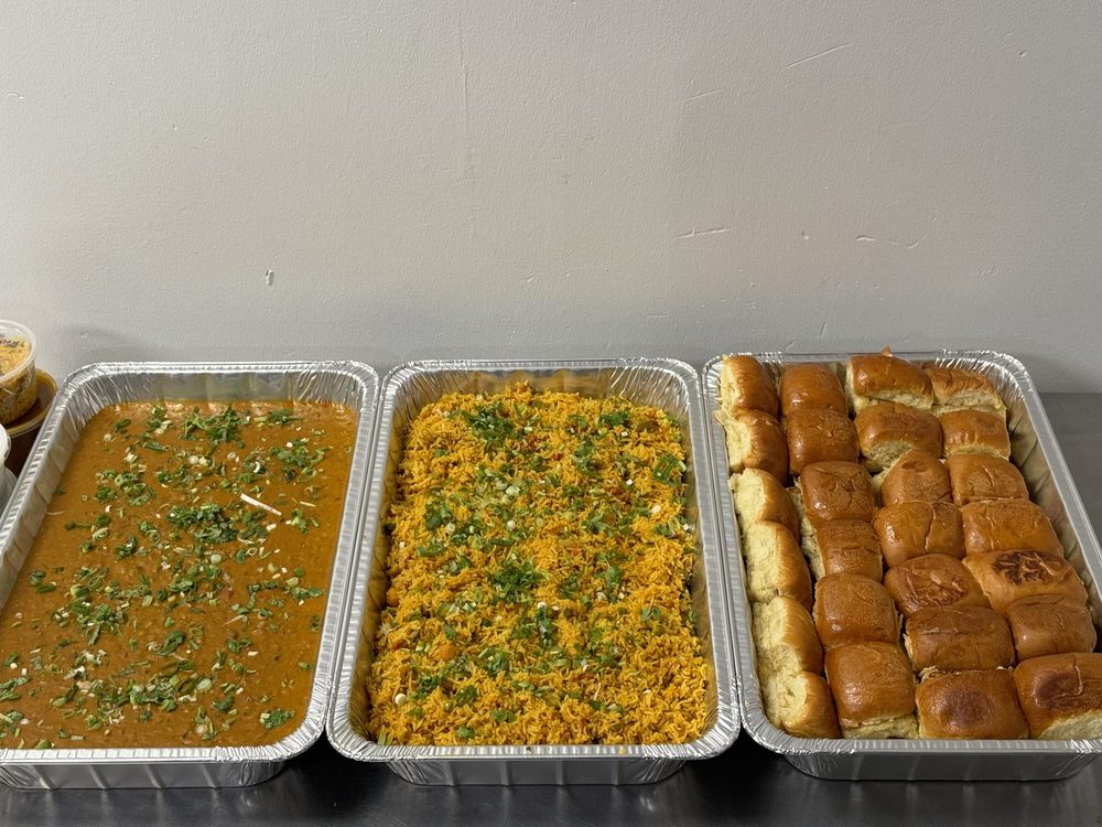 Catering trays of dal, sabji and dhokla