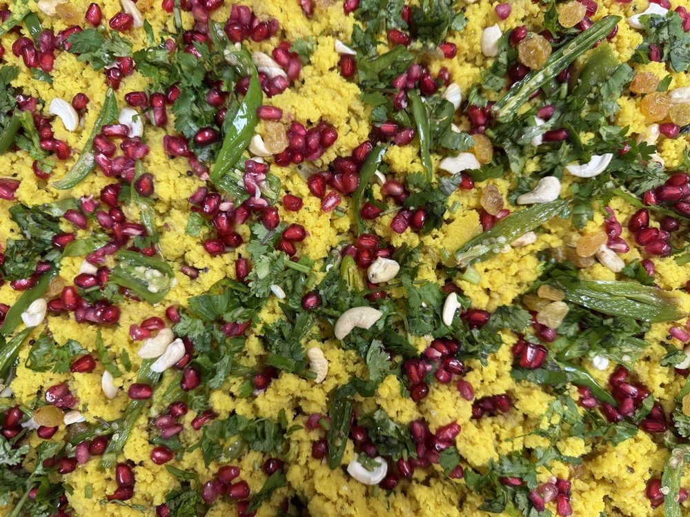Poha with pomegranate, cashew and coriander