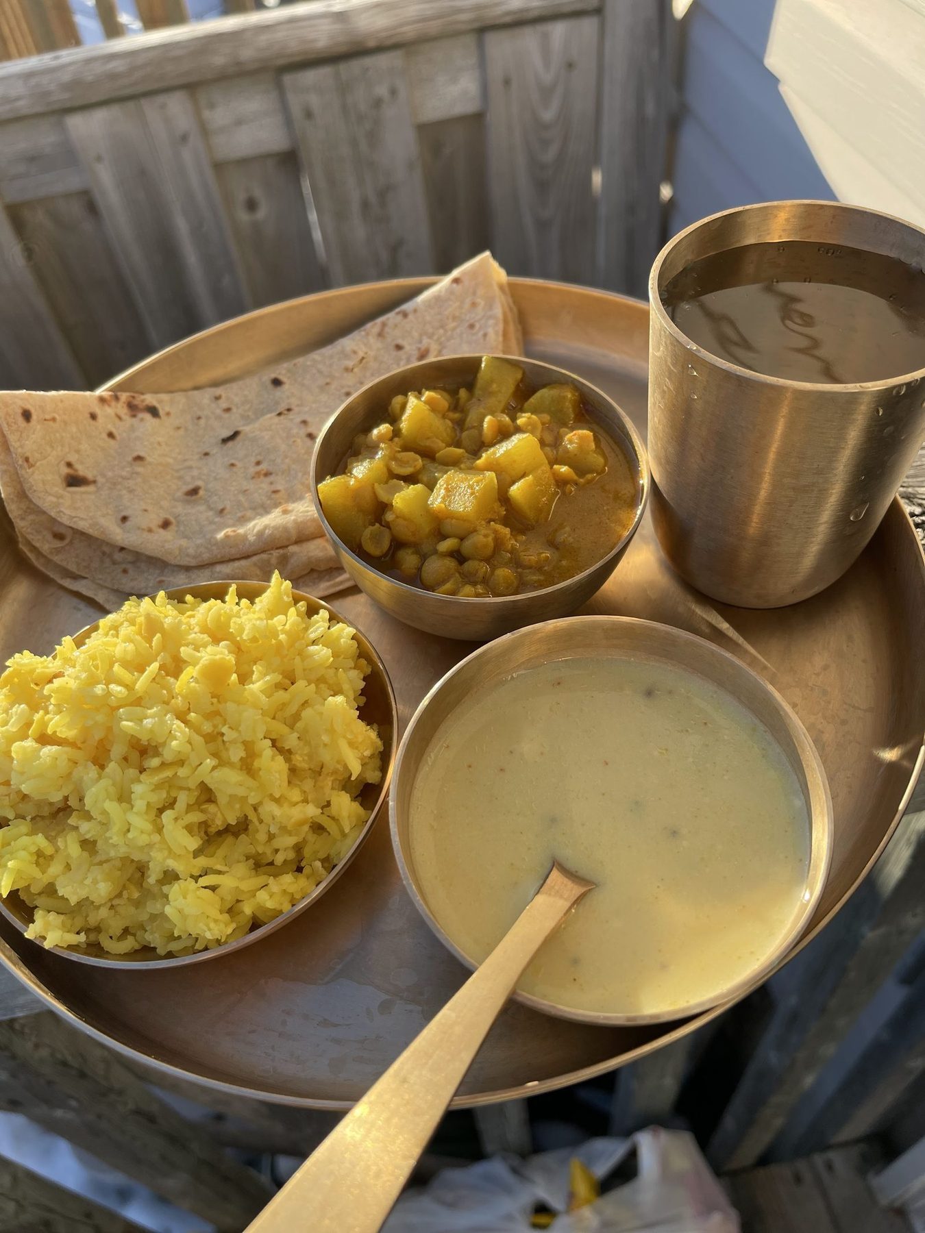 A single-day tiffin: roti, sabji, dal and rice