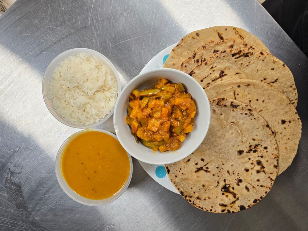 Rotli, shaak, dal and rice from above